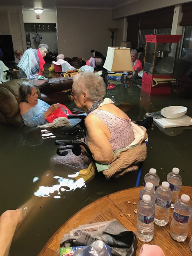 Nursing home residents wait to be rescued in waist high flood waters.