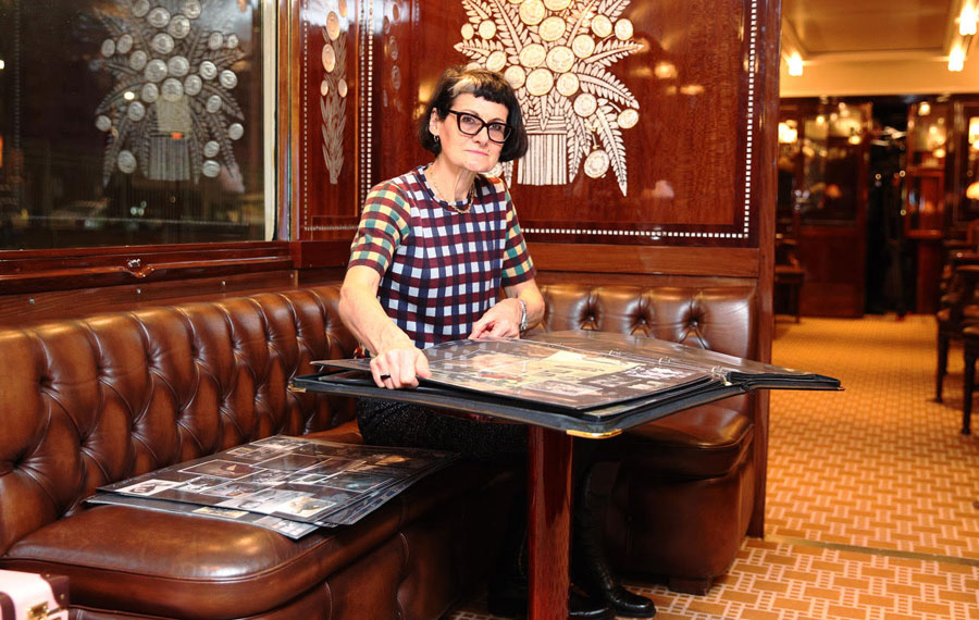 Costume designer Alexandra Byrne turning the page on one of her her mood books.