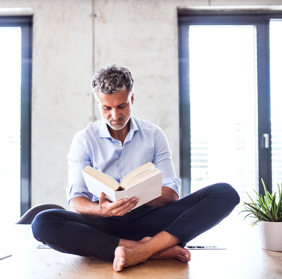 Man sitting on table reading.