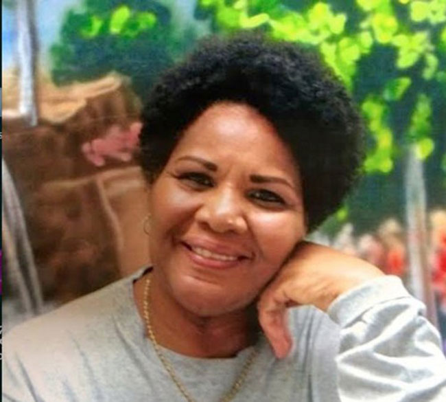 A photo of Alice Marie Johnson with resting her face on her hand.