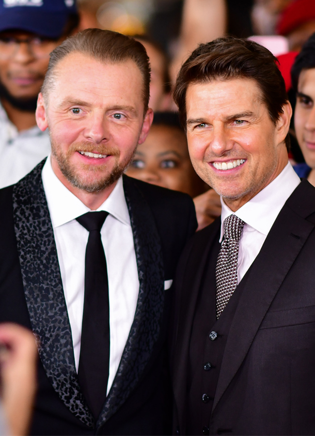 Simon Pegg and Tom Cruise posing for photos at the Mission Impossible Fallout premiere