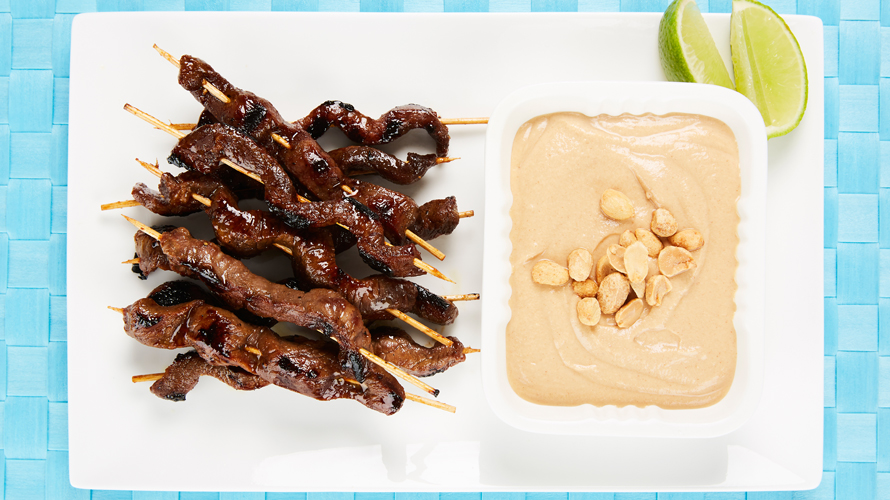 Beef shish kabobs with peanut sauce.