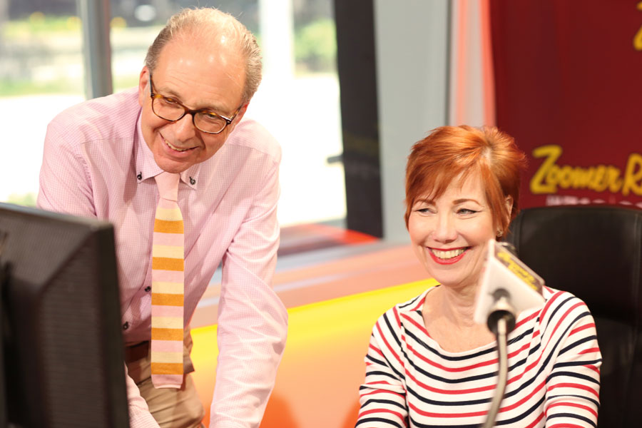 Intern, Lawrence Franklin with radio personality Libby Znaimer smiling at a computer screen.