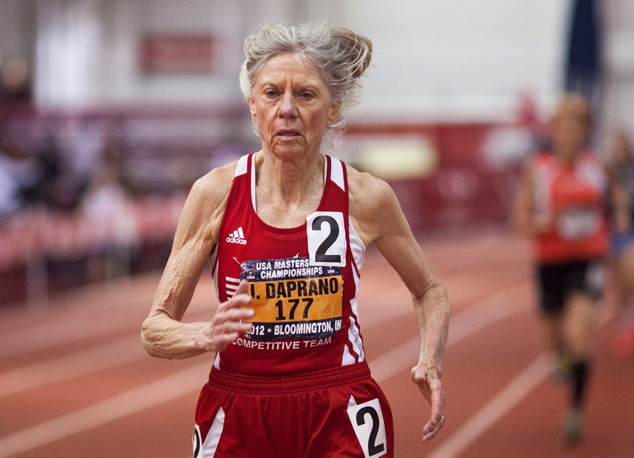 81-year-old Jeanne Daprano in mid-stride on the track.