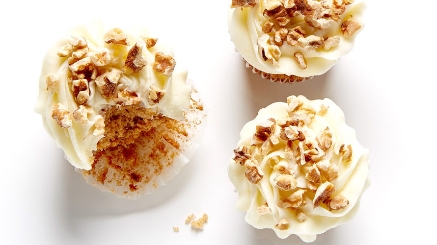 Carrot cupcakes with white frosting.