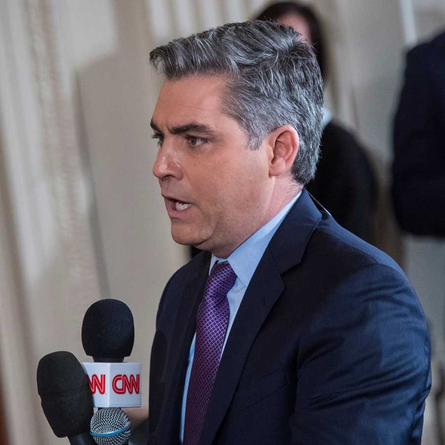 Jim Costa asking questions at a White House press conference holding a CNN Microphone.