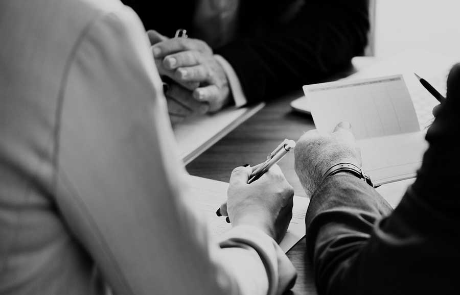 Two people sitting down in front of a financial advisor.