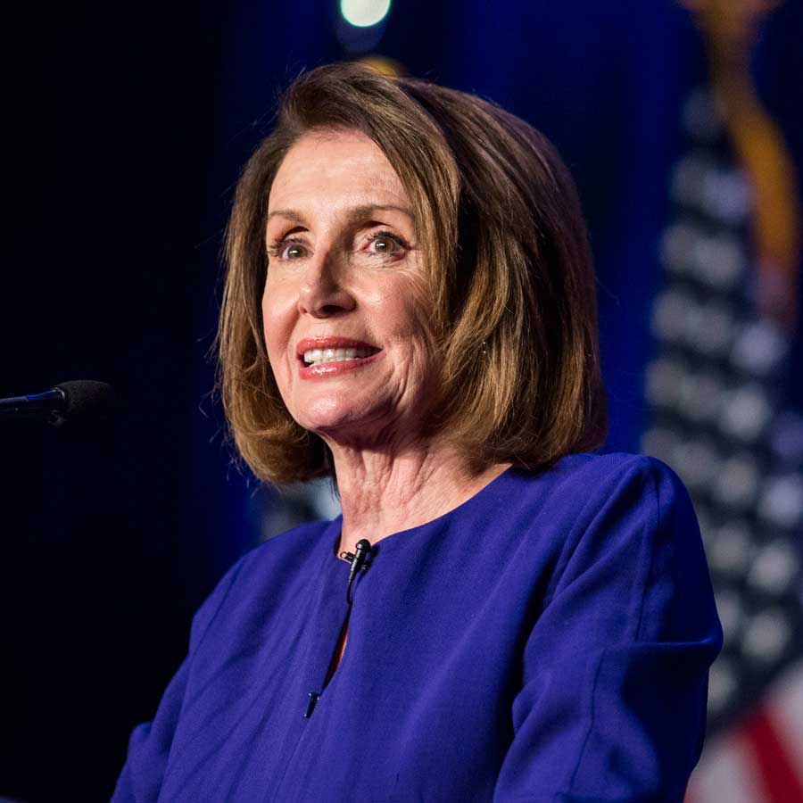 Nancy Pelosi on election night smiling over a crowd of supporters after her big win.