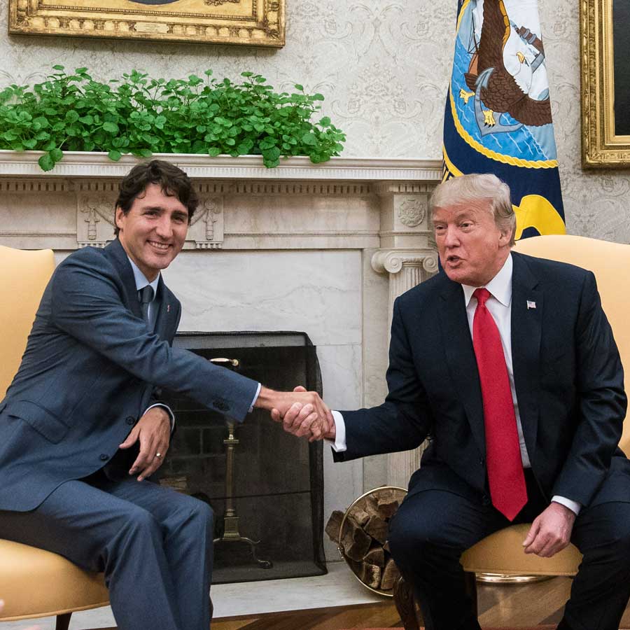 Trump and Trudeau shake hands inside the White House.