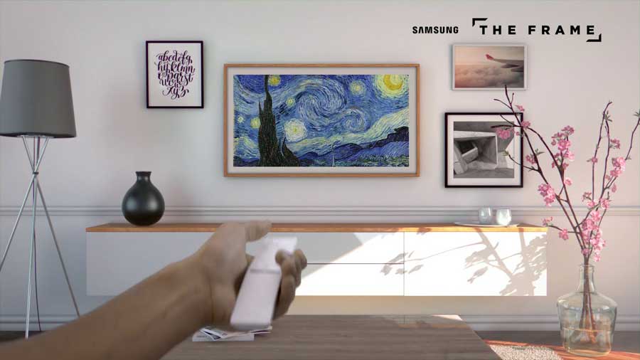 A photo of a family room with a couch and multiple paintings on the wall along with The Frame television which looks like another piece of art.