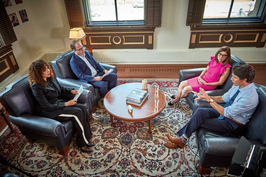 Justin Trudeau and Filomena Tassi sit across from Zoomer Magazine editors during a Q&A.