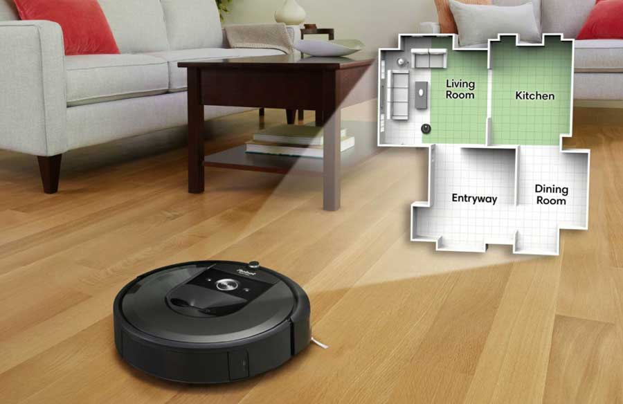 A Roomba vacuum on the hardwood floor of a family room.