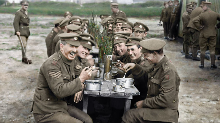 British soldiers sit down for a meal during the first world war.