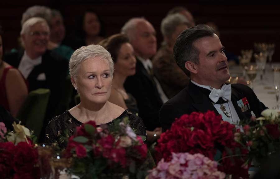Glenn Close in The Wife listens as her onscreen husband accepts an award.