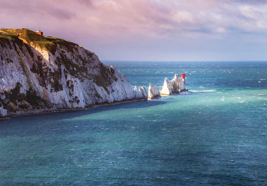 A mountain emerging from the bright blue water at the Isle of Wight.