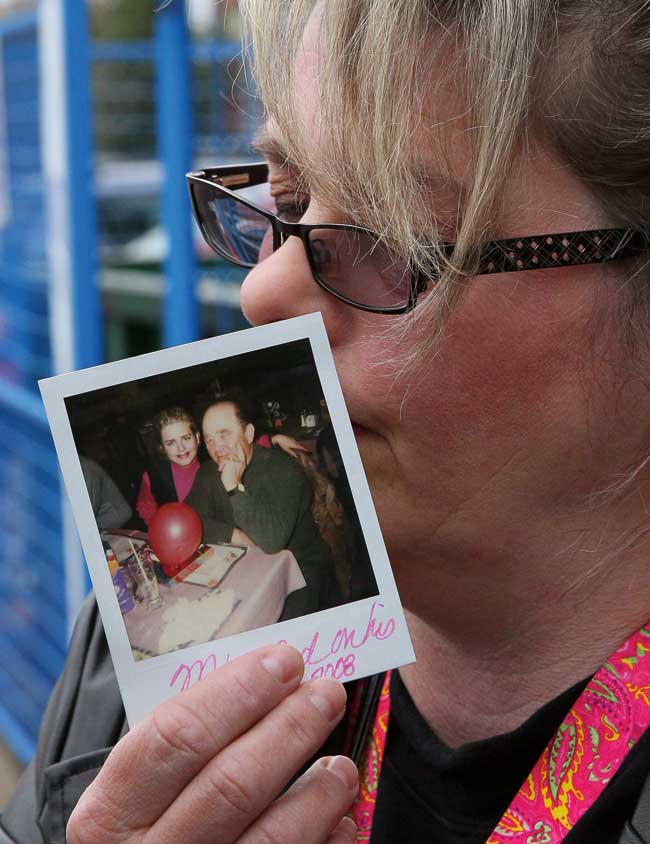 Susan Horvath, daughter of victim Arpad Horvath, holds a photo of her father from his 70th birthday as she speaks to the media outside the court house in Woodstock, Ont., on Friday, April 21, 2017