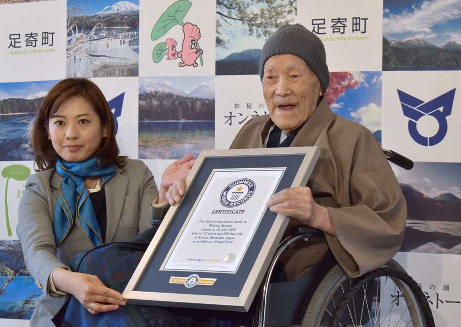 Masazo Nonaka of Japan (R), aged 112, receives a certificate for the Guinness World Records&#039; oldest male person living title from Erika Ogawa (L), vice president of Guinness World Records Japan, in Ashoro, Hokkaido prefecture on April 10, 2018