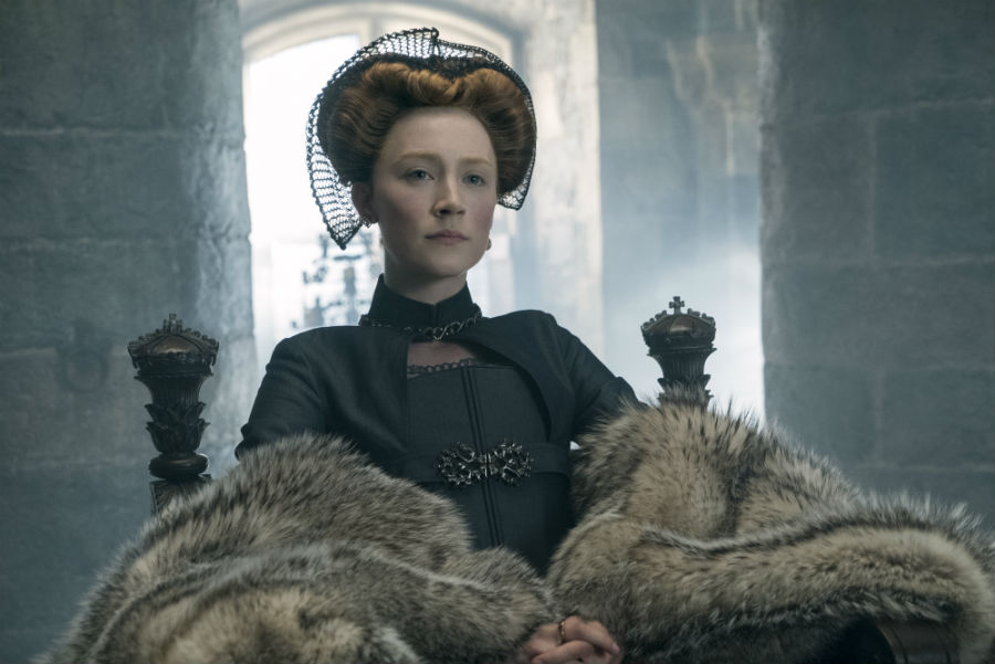 A woman sits on a throne with a fur coat laid across her lap.