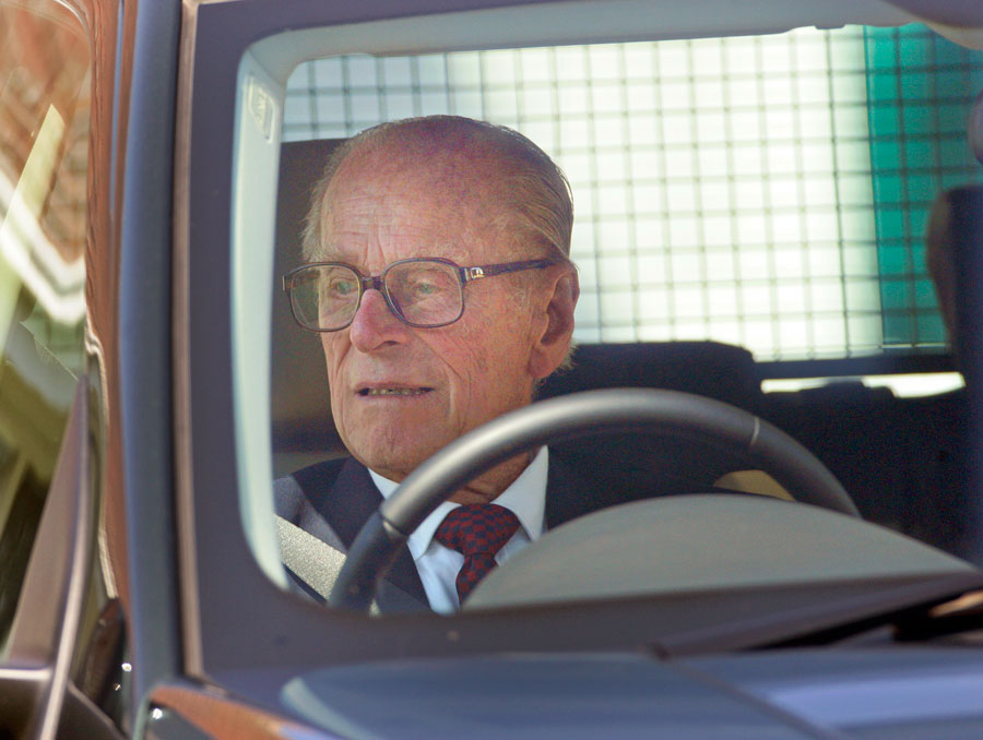 Prince Phillip wearing glasses while driving.