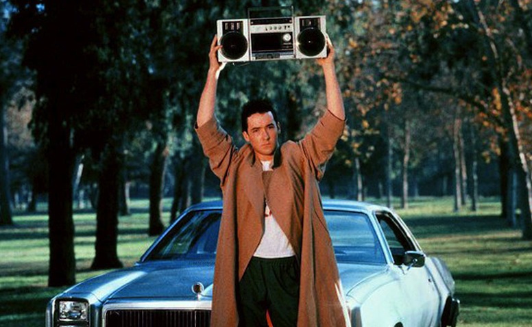 John Cusack holds a boom box over his head in Say Anything.