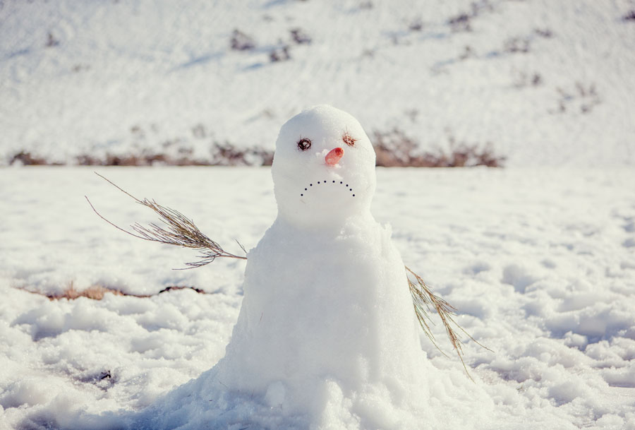 A snowman melting in the sun.