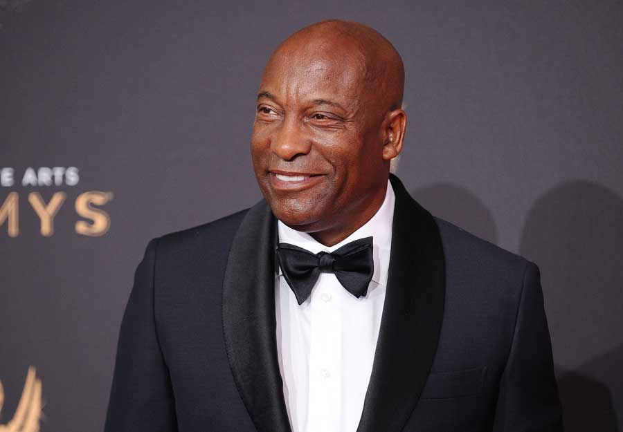 John Singleton smiling wearing a tuxedo.