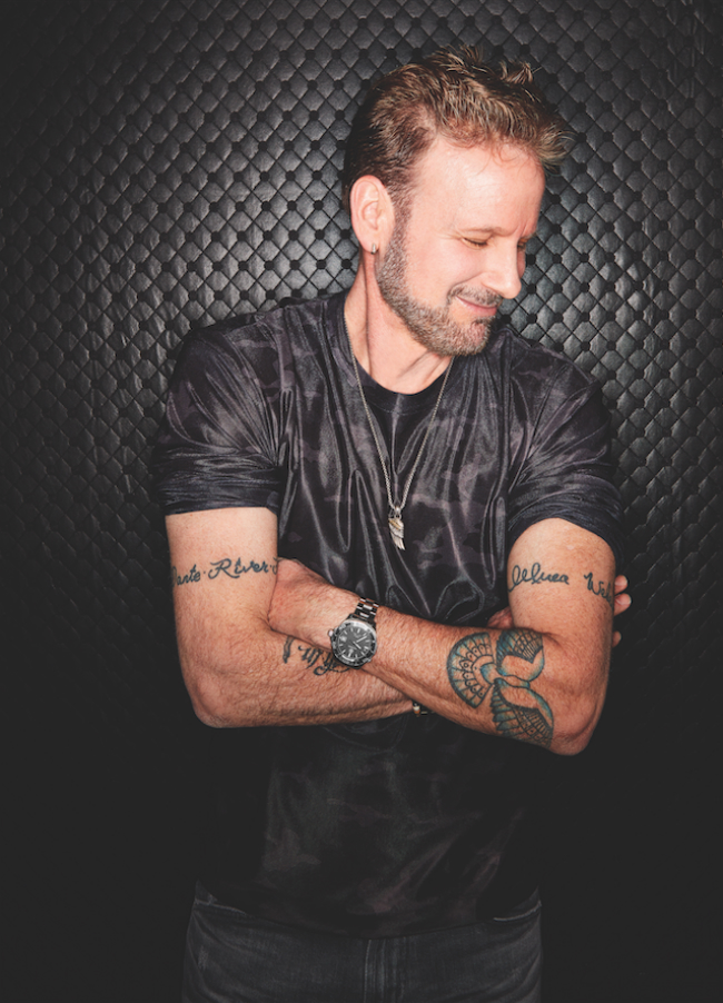 A photo of Corey Hart with his arms crossed.