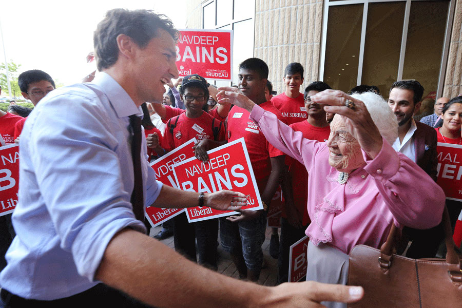 Hazel McCallion and Trudeau at a rally about to give one another a hug.