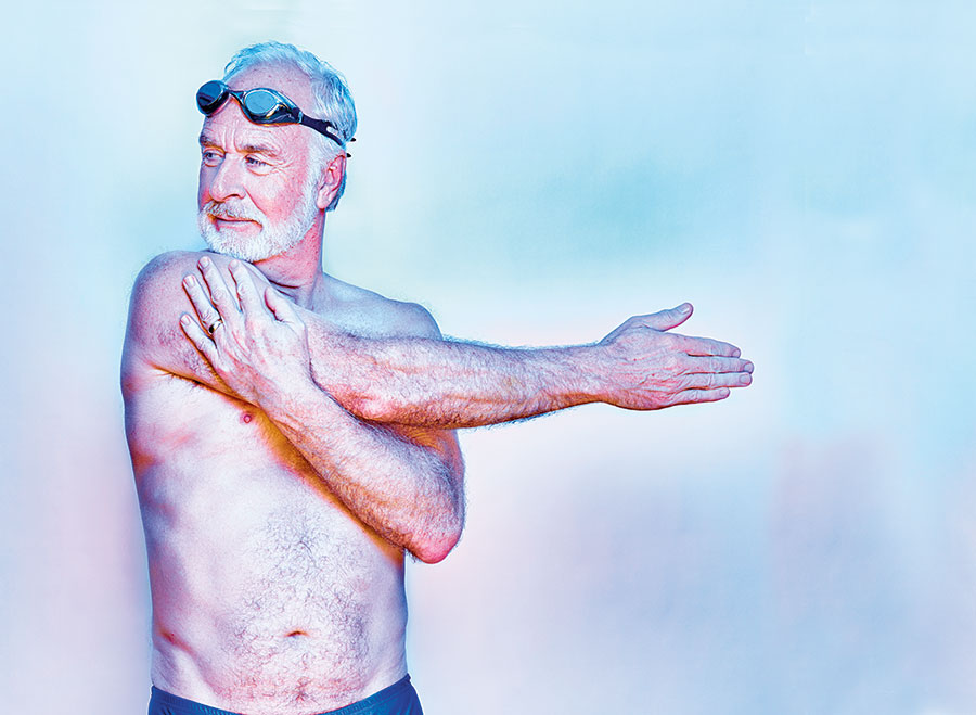A man stretching in swimming gear