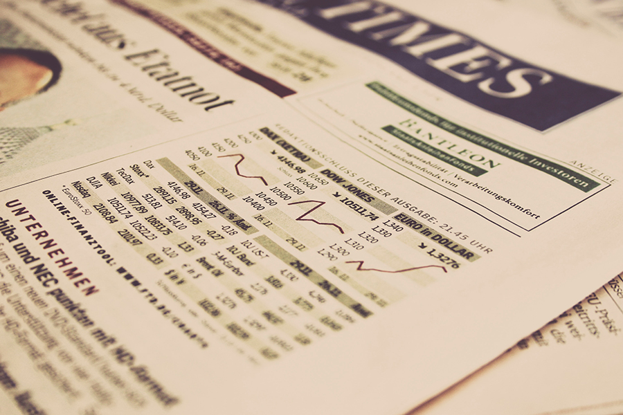 A picture of the financial section of a newspaper, showing stock prices and market levels.