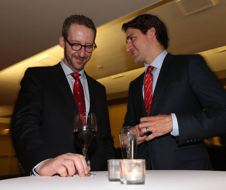 Justin Trudeau and Gerald Butts speak to one another at the Royal York Hotel.