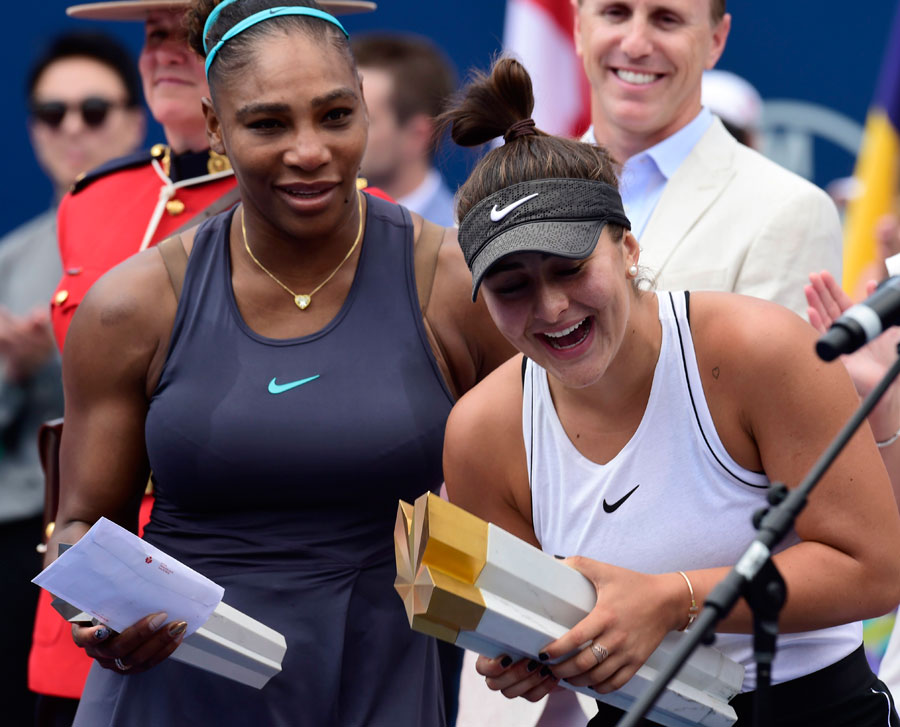 Canada&#039;s Bianca Andreescu holds the winner&#039;s trophy as Serena Williams of the USA looks on