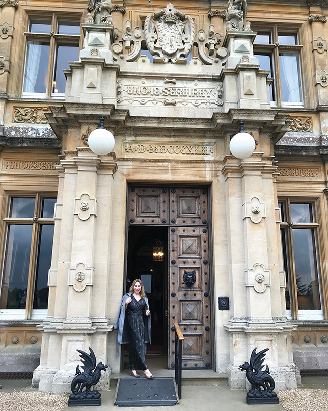 A photo of the author, Vivian Vassos outside of Highclere Castle.