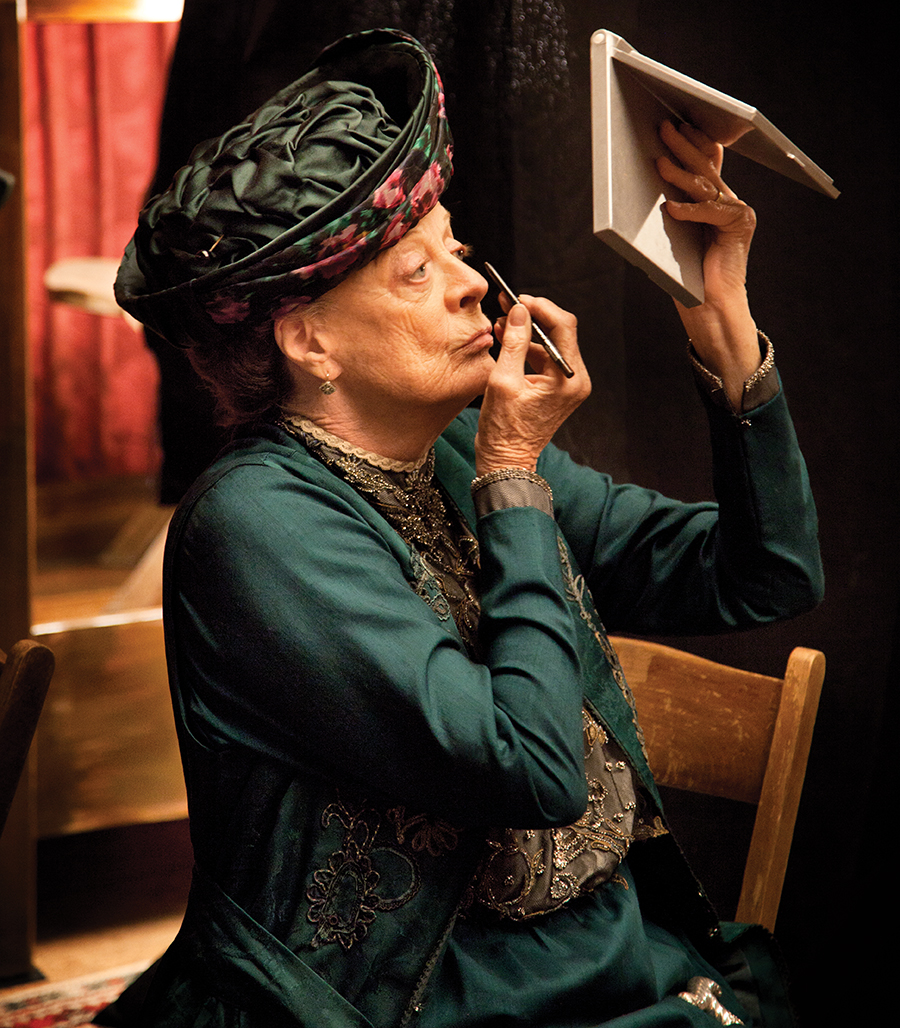 A photo of Maggie Smith doing her makeup on the set of Downton Abbey.