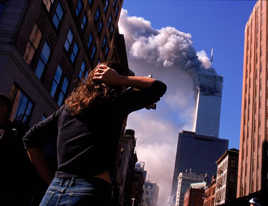 Shocked crowds of downtown Manhattanites observe the burning World Trade Center towers in New York City early September 11, 2001. Three hijacked planes crashed into major U.S. landmarks on the same day, destroying both of New York's twin towers and plunging the Pentagon in Washington into flames, in an unprecedented assault on key symbols of U.S. military and financial power.