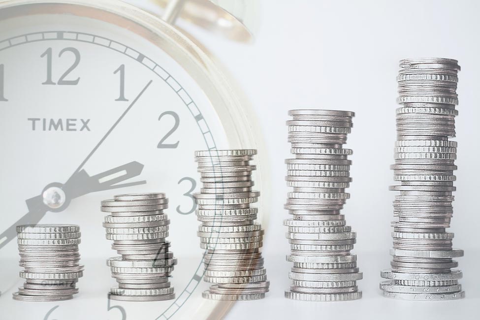 A growing investment - a stack of silver coins with a clock.