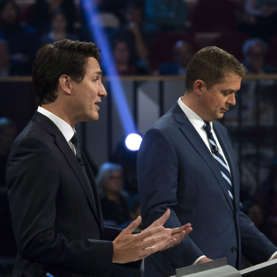 Conservative leader Andrew Scheer makes notes as Liberal leader Justin Trudeau speaks during the Federal leaders debate in Gatineau, Que. on Monday, October 7, 2019. THE CANADIAN PRESS/Sean Kilpatrick