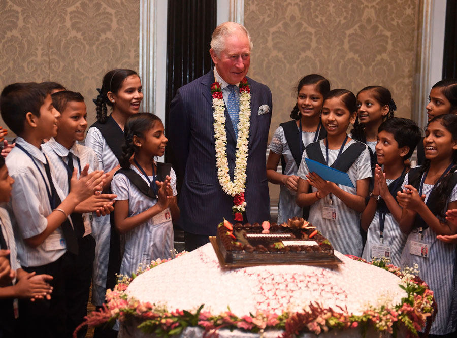 Britain's Prince Charles interacts with children from the Kaivalya Education Foundation supported by the British Asian trust.
