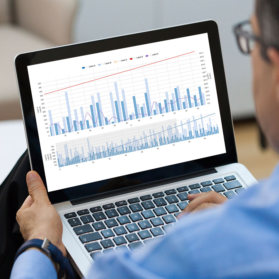 Businessman looking Financial Charts on laptop.