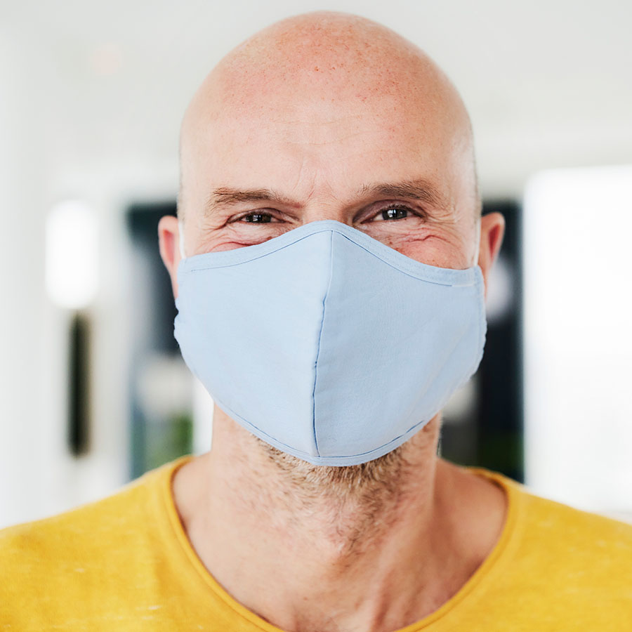 Bald man wearing a covid face mask