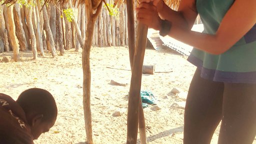 My host siblings are teaching me how to pound mahangu. It's a lot hard than it looks.