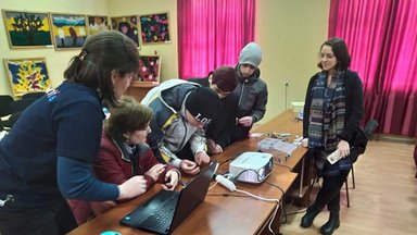 Julia teaching three students with her counterparts