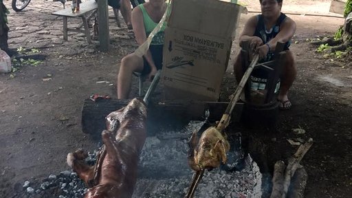 Roasting a lechon baboy (roast pig) with host cousin Jordon, who roasts a turkey