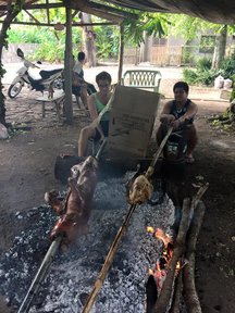 Roasting a lechon baboy (roast pig) with host cousin Jordon, who roasts a turkey