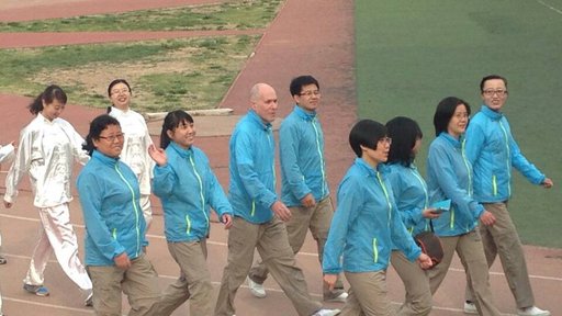Lawrence Kahn marches in a Sports Day celebration with members of the English department at his university site in Lanzhou.