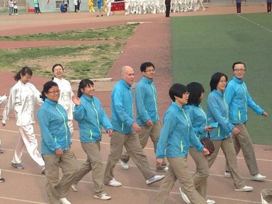 Lawrence Kahn marches in a Sports Day celebration with members of the English department at his university site in Lanzhou.