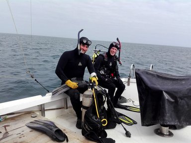 Peace Corps Response volunteer Christopher Giordano (right) with Dr. Yuri Hooker (left) before the first dive of their investigation. They were filming and cataloguing the marine species offshore Cabo Blanco for the first time ever.
