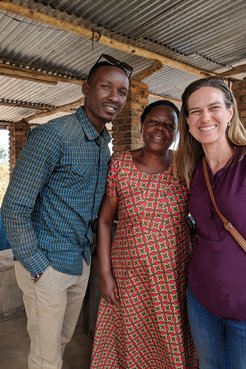 Kait standing with two people from the Shining Coffee company in Rwanda