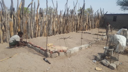 My host siblings and I using extra equipment found around our homestead to create a fence for our soon to be garden.