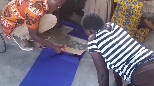 Girls observing how to make reusable menstrual pads